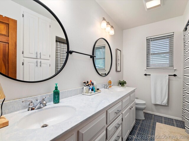 full bath with tile patterned floors, toilet, double vanity, and a sink