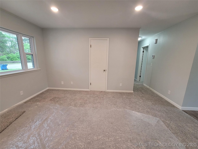 empty room with baseboards, recessed lighting, and carpet flooring