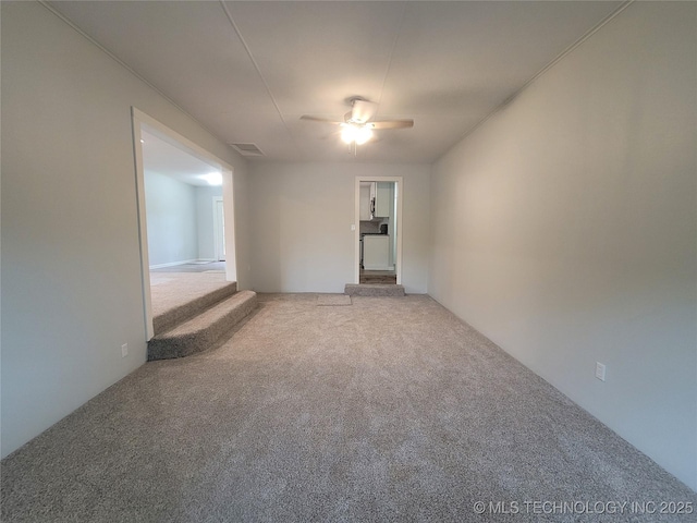 unfurnished room featuring carpet, ceiling fan, and visible vents