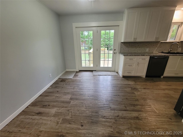 kitchen featuring a sink, dishwasher, white cabinetry, and dark wood-type flooring