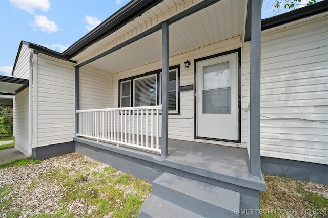 view of exterior entry featuring a porch