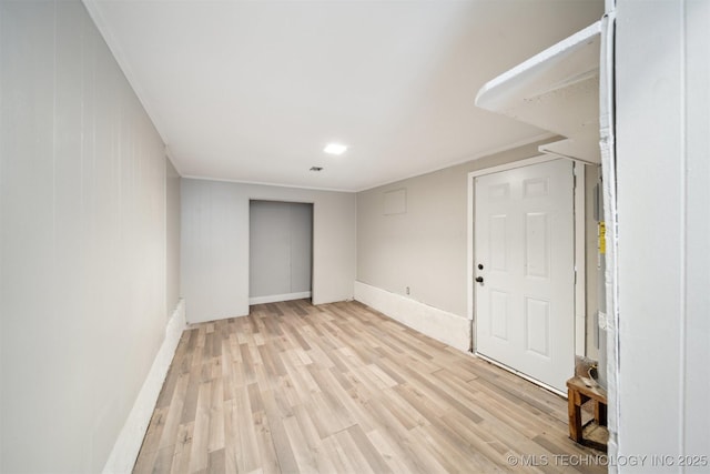 unfurnished room with baseboards and light wood-type flooring