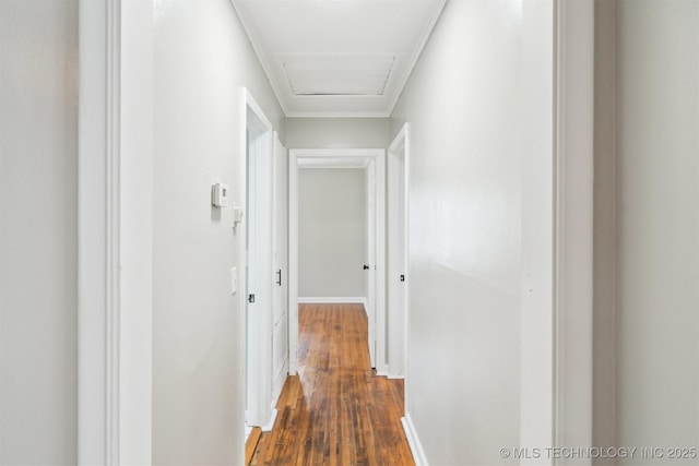 hall featuring attic access, dark wood-style floors, and baseboards