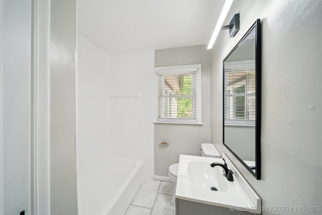 bathroom with vanity, toilet, marble finish floor, and baseboards