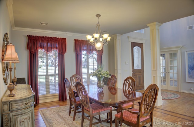 8160 S 270th E Ave, Broken Arrow, OK 74014 - dining area featuring a chandelier, wood finished floors, ornate columns, and crown molding