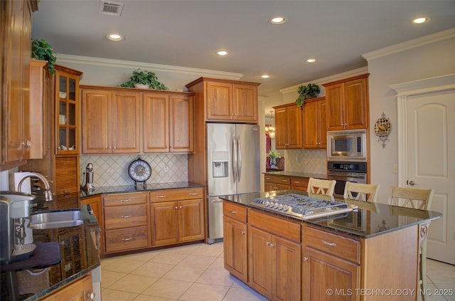 8160 S 270th E Ave, Broken Arrow, OK 74014 - kitchen featuring stainless steel appliances, a sink, dark stone counters, recessed lighting, and backsplash