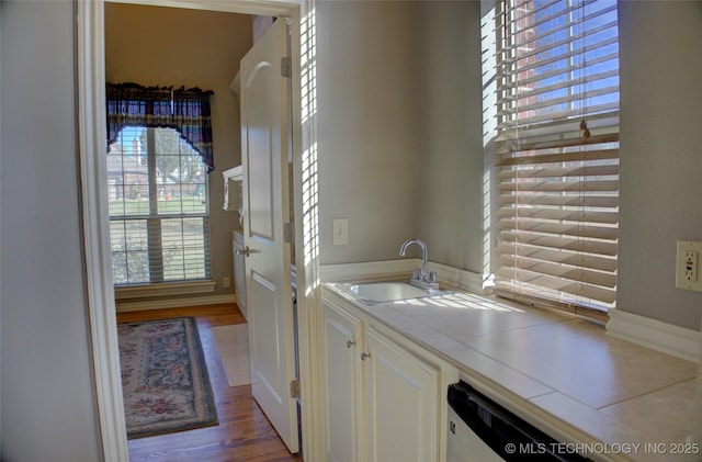 8160 S 270th E Ave, Broken Arrow, OK 74014 - laundry room with a sink, wood finished floors, and baseboards