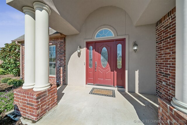 19434 S Quail Run Ct, Claremore, OK 74017 - doorway to property with brick siding and stucco siding