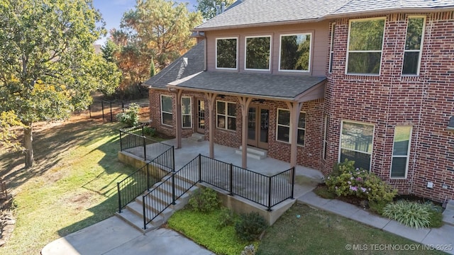19434 S Quail Run Ct, Claremore, OK 74017 - rear view of house with brick siding, a shingled roof, and a patio