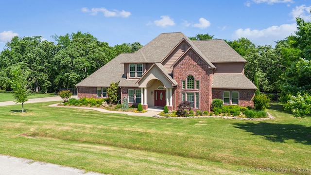 19434 S Quail Run Ct, Claremore, OK 74017 - traditional-style house with brick siding, a front lawn, and a shingled roof