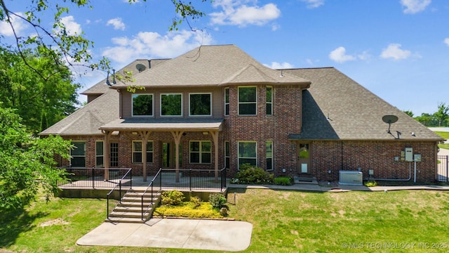 19434 S Quail Run Ct, Claremore, OK 74017 - back of house with a yard, roof with shingles, brick siding, and a patio