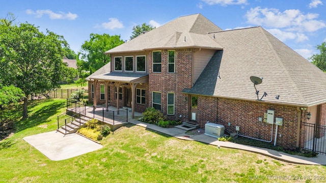 19434 S Quail Run Ct, Claremore, OK 74017 - rear view of house featuring brick siding, a patio, entry steps, and roof with shingles