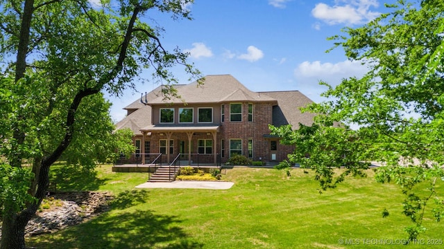19434 S Quail Run Ct, Claremore, OK 74017 - back of house featuring brick siding and a yard