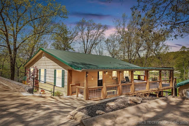 5068 County Road 370, Eucha, OK 74342 - view of front of house featuring a porch, driveway, and metal roof