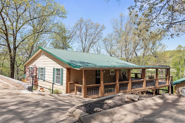 5068 County Road 370, Eucha, OK 74342 - exterior space featuring a porch, metal roof, and aphalt driveway