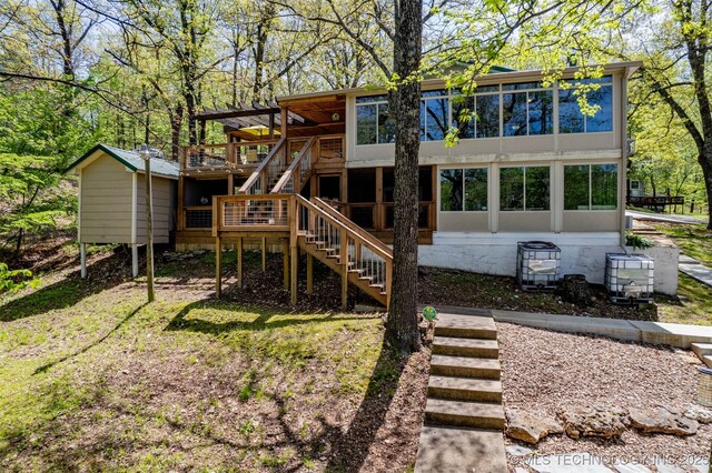 5068 County Road 370, Eucha, OK 74342 - view of play area with a sunroom, a deck, and stairway