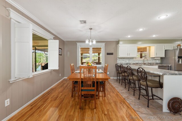 5068 County Road 370, Eucha, OK 74342 - dining space with a chandelier, visible vents, light wood-type flooring, and ornamental molding
