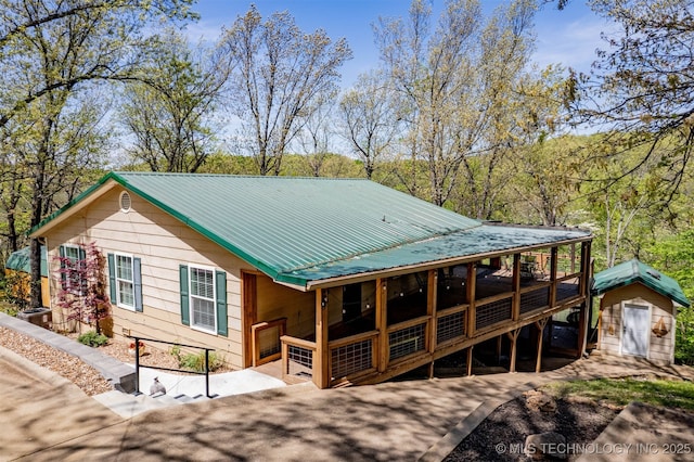 5068 County Road 370, Eucha, OK 74342 - back of house featuring metal roof, a storage shed, and an outbuilding