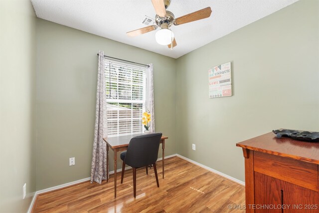 5068 County Road 370, Eucha, OK 74342 - home office with light wood-style flooring, a ceiling fan, and baseboards