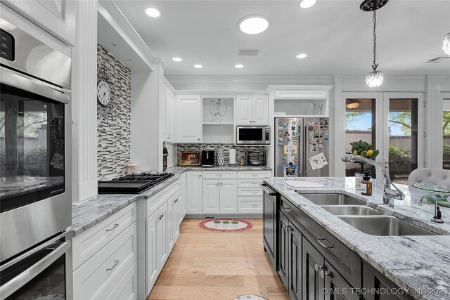 4829 S Zunis Ave, Tulsa, OK 74105 - kitchen with a sink, stainless steel appliances, open shelves, visible vents, and white cabinetry
