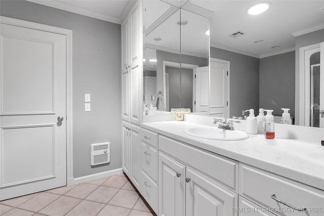 4829 S Zunis Ave, Tulsa, OK 74105 - bathroom featuring crown molding, visible vents, heating unit, vanity, and tile patterned flooring