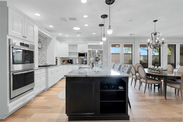 4829 S Zunis Ave, Tulsa, OK 74105 - kitchen featuring white cabinetry, open shelves, appliances with stainless steel finishes, a center island with sink, and backsplash