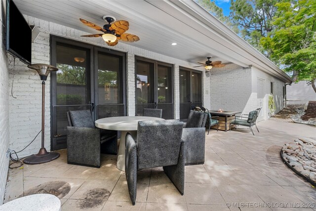 4829 S Zunis Ave, Tulsa, OK 74105 - view of patio featuring a ceiling fan, outdoor dining space, and an outdoor fire pit
