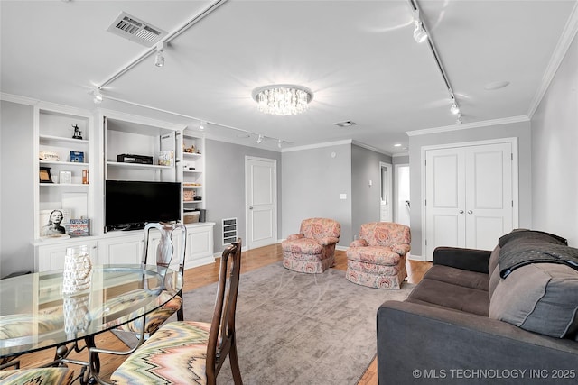 4829 S Zunis Ave, Tulsa, OK 74105 - living room with an inviting chandelier, crown molding, track lighting, visible vents, and wood finished floors