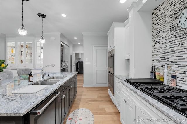 4829 S Zunis Ave, Tulsa, OK 74105 - kitchen featuring a kitchen island with sink, a sink, stainless steel appliances, light wood-type flooring, and white cabinets