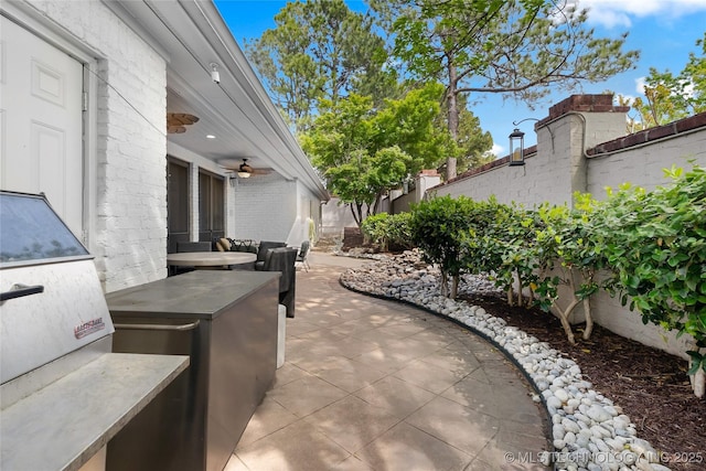 4829 S Zunis Ave, Tulsa, OK 74105 - view of patio / terrace featuring a ceiling fan and fence