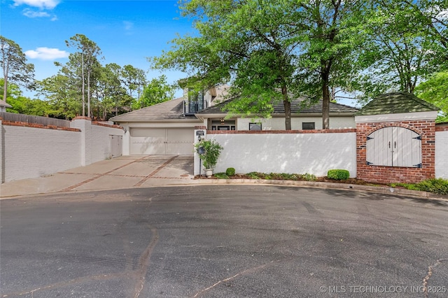 4829 S Zunis Ave, Tulsa, OK 74105 - exterior space featuring a garage, fence, and concrete driveway