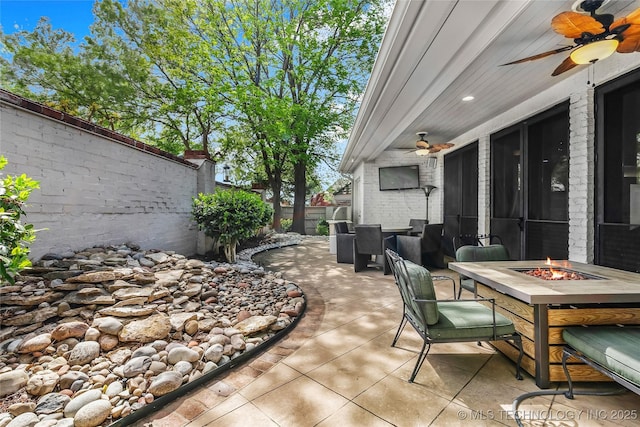 4829 S Zunis Ave, Tulsa, OK 74105 - view of patio featuring ceiling fan, an outdoor fire pit, and a fenced backyard