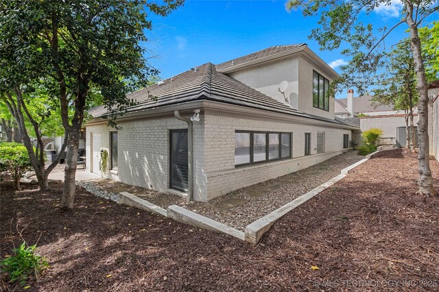 4829 S Zunis Ave, Tulsa, OK 74105 - view of property exterior with central air condition unit and brick siding