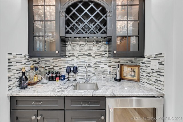 4829 S Zunis Ave, Tulsa, OK 74105 - bar featuring beverage cooler, a sink, indoor wet bar, and decorative backsplash