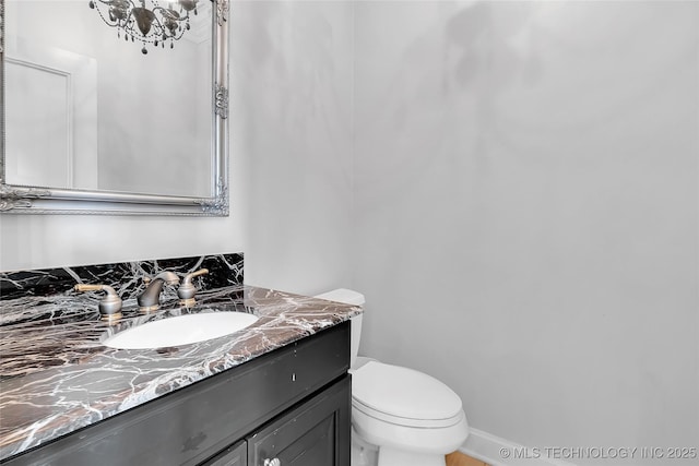 4829 S Zunis Ave, Tulsa, OK 74105 - bathroom with toilet, a chandelier, and vanity