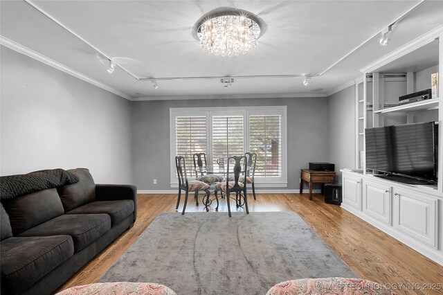 4829 S Zunis Ave, Tulsa, OK 74105 - living room featuring ornamental molding, light wood finished floors, a notable chandelier, and rail lighting