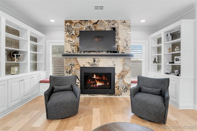 4829 S Zunis Ave, Tulsa, OK 74105 - living area featuring light wood-type flooring, visible vents, ornamental molding, and a large fireplace