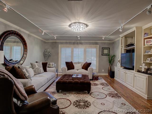 4829 S Zunis Ave, Tulsa, OK 74105 - living area featuring crown molding, an inviting chandelier, rail lighting, and wood finished floors