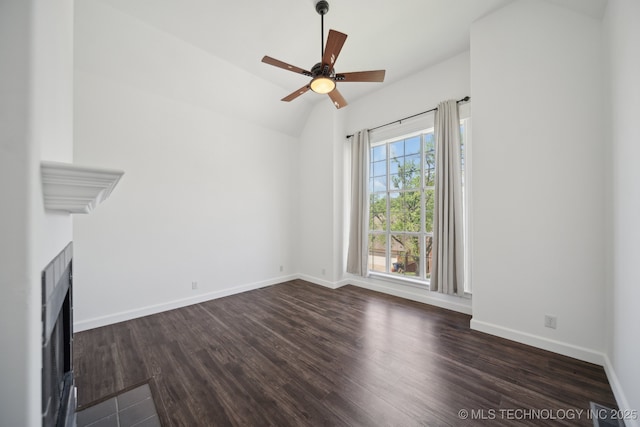 unfurnished living room with baseboards, lofted ceiling, dark wood-style floors, and a fireplace