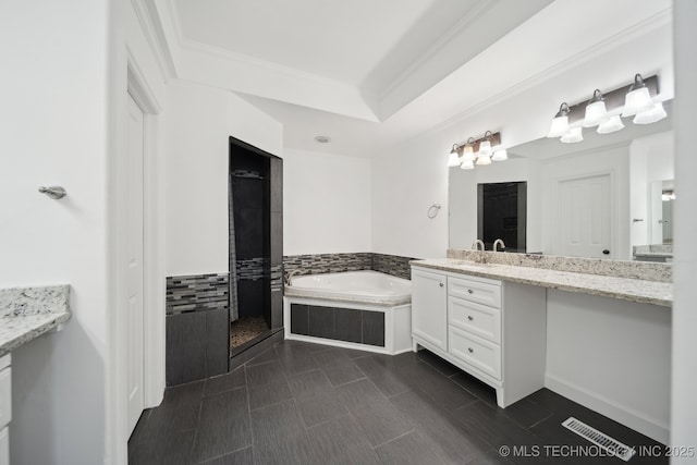 full bath featuring vanity, ornamental molding, a garden tub, and tiled shower