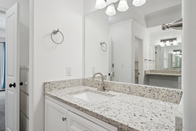 bathroom with vanity and ornamental molding