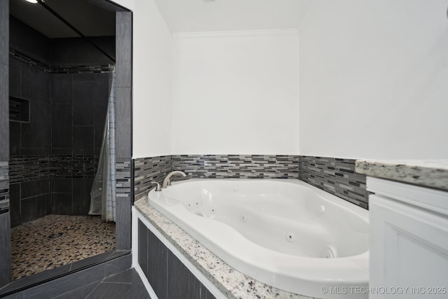 full bathroom featuring a tile shower, a whirlpool tub, and ornamental molding