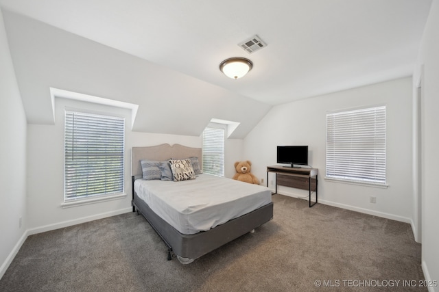 carpeted bedroom with baseboards, visible vents, and vaulted ceiling