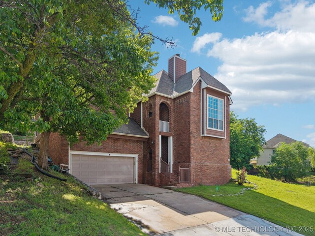 view of front of property featuring brick siding, a front lawn, driveway, and a chimney