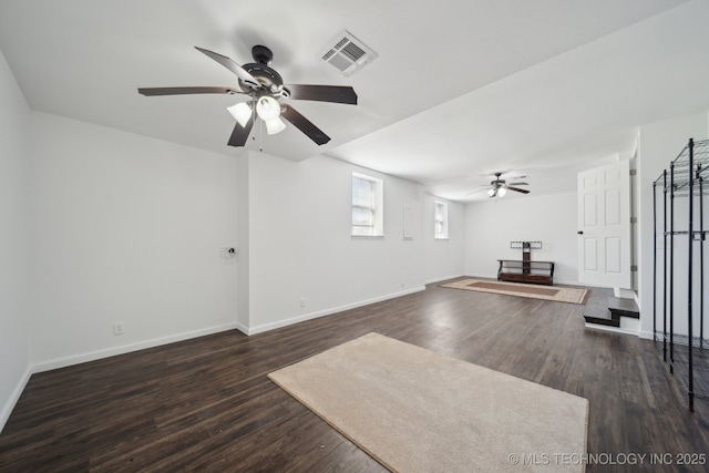 unfurnished living room featuring baseboards, a ceiling fan, dark wood-style flooring, and visible vents