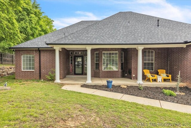 13215 E 182nd Cir, Bixby, OK 74008 - back of house with a shingled roof, brick siding, and a lawn