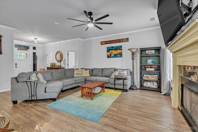 13215 E 182nd Cir, Bixby, OK 74008 - living area with ceiling fan, ornamental molding, light wood-style floors, a fireplace, and baseboards