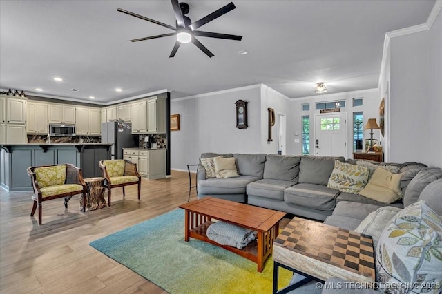 13215 E 182nd Cir, Bixby, OK 74008 - living room with crown molding, a ceiling fan, light wood-type flooring, and recessed lighting