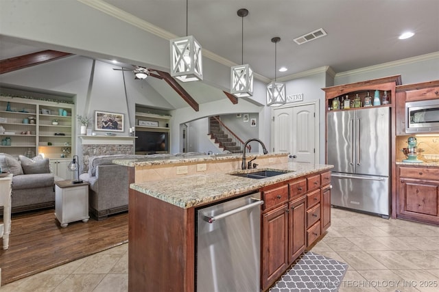 14530 S Gary Pl, Bixby, OK 74008 - kitchen with a sink, stainless steel appliances, a fireplace, visible vents, and open floor plan