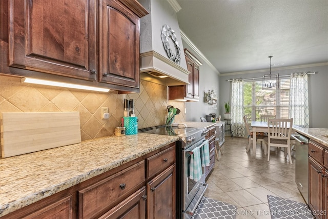 14530 S Gary Pl, Bixby, OK 74008 - kitchen with stainless steel appliances, decorative backsplash, custom range hood, ornamental molding, and hanging light fixtures